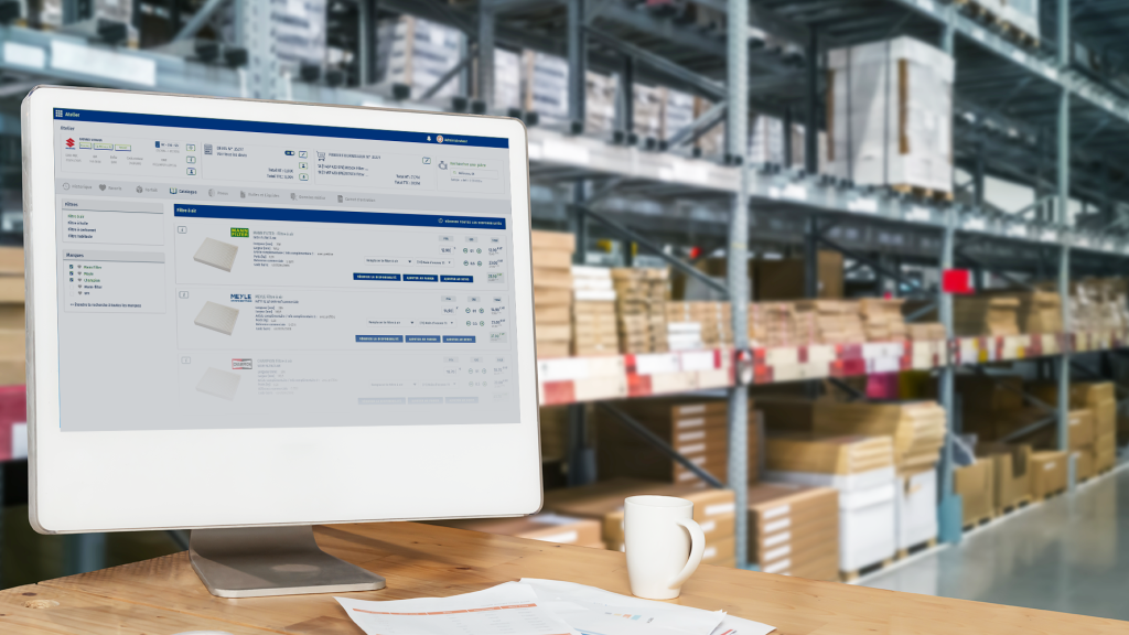 Computer on desk in parts distribution shop showing a parts management system from Infopro Digital Automotive