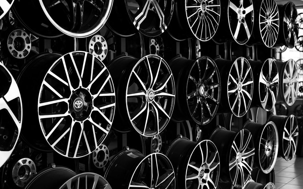Shop display wall with many car rims representing Product DriveRightData Wheel Fitment