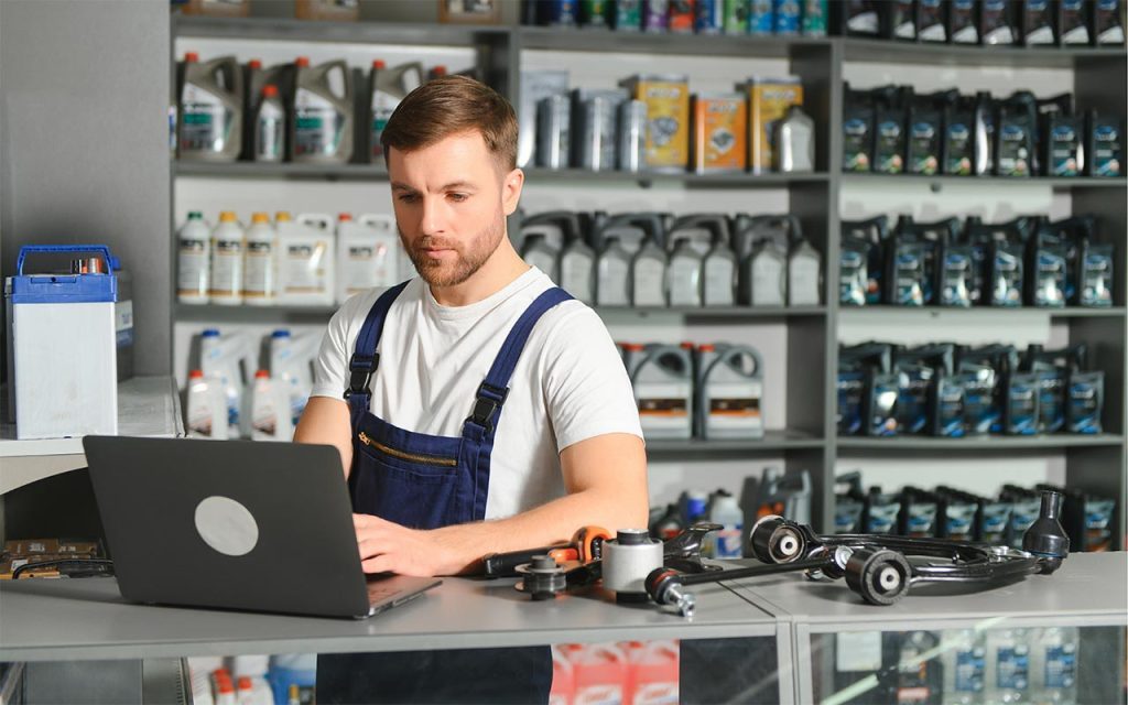 Salesman in a car parts and accessories shop, one of the leading players in the automotive aftermarket sector