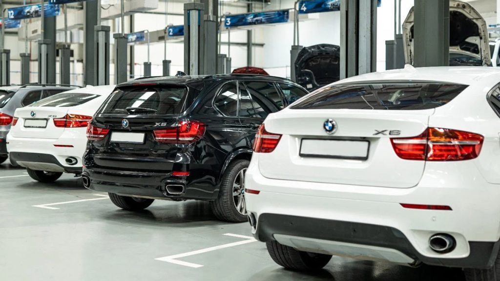 BMW European vehicles inside a U.S. repair workshop, using diagnostic tools and OEM technical data for accurate repair procedures.