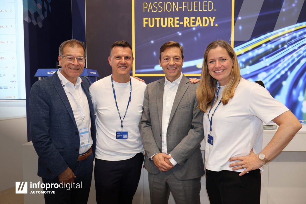 Four representatives of TOPMOTIVE and Infopro Digital Automotive standing together at Automechanika Frankfurt 2026