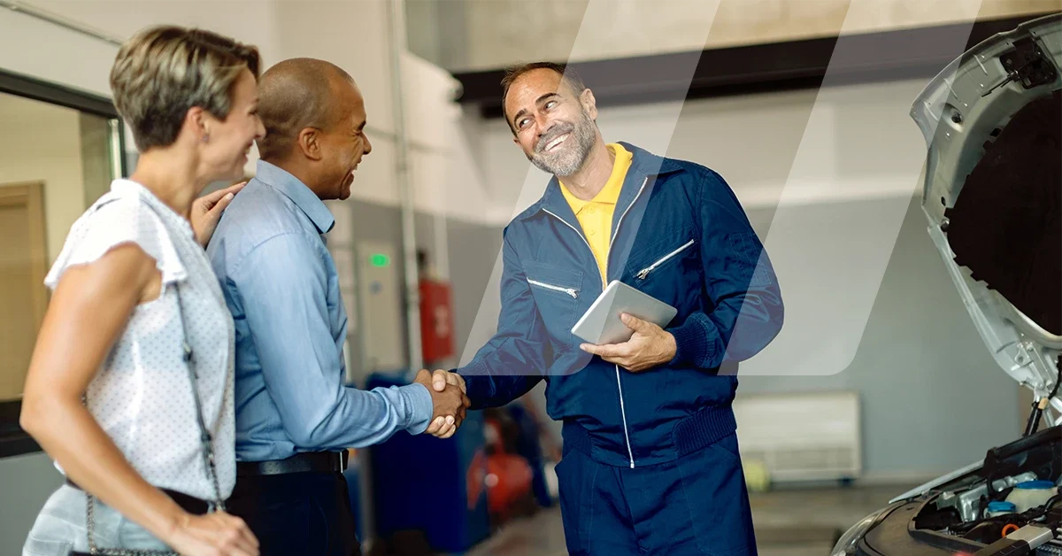 Car mechanic smiling while talking to customers