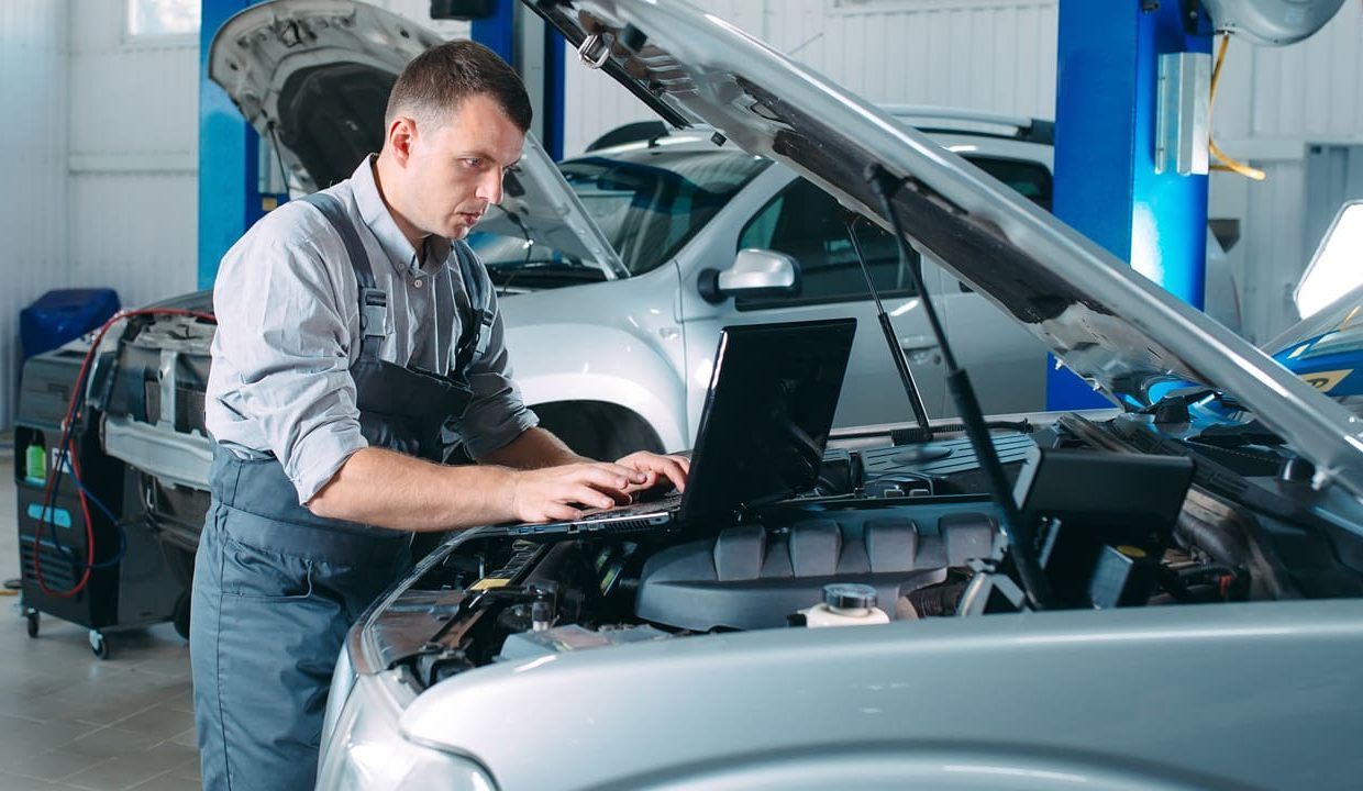Mechanic working on a vehicle in the workshop using data and software from Infopro for Workshops and Fast Fitters