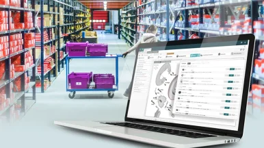 Computer with a spare parts catalogue integrating haynespro's technical data with the background of a spare parts warehouse