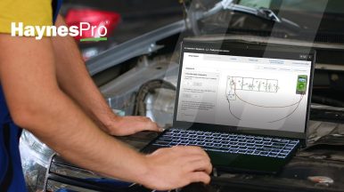 Close-up of a mechanic using HaynesPro’s new engine component replacement procedures and wiring diagrams