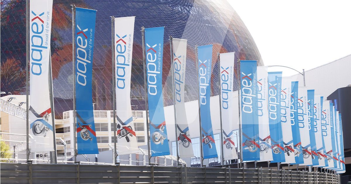 Exterior view of AAPEX 2025 in Las Vegas with flags where Infopro Digital Automotive presents AI-based solutions for automotive data.