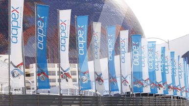 Exterior view of AAPEX 2025 in Las Vegas with flags where Infopro Digital Automotive presents AI-based solutions for automotive data.